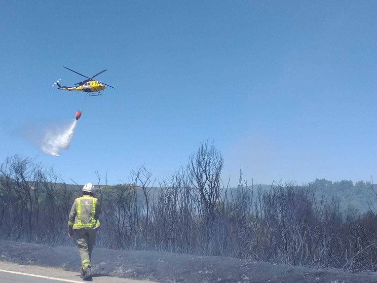 O único helicóptero desprazado nas labores de extinción do lume en Guimarei. | FOTO: Xosé Lois Colmenero
