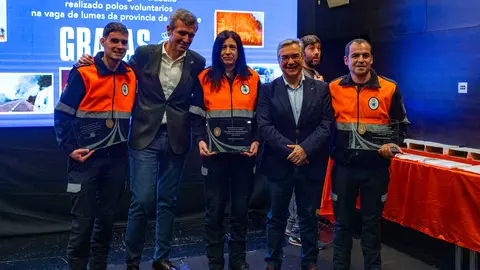Los tres voluntarios de la Agrupaci&oacute;n verinense, con el presidente de la Xunta, Alfonso Rueda, y el presidente de la Deputaci&oacute;n de Ourense, Luis Menor.